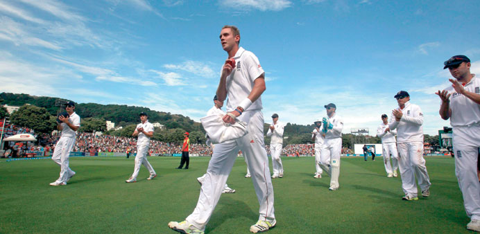 Englandu2019s Stuart Broad (C) is applauded by team mates while walking off the ground after taking six wickets against New Zealand at the Basin Reserve i