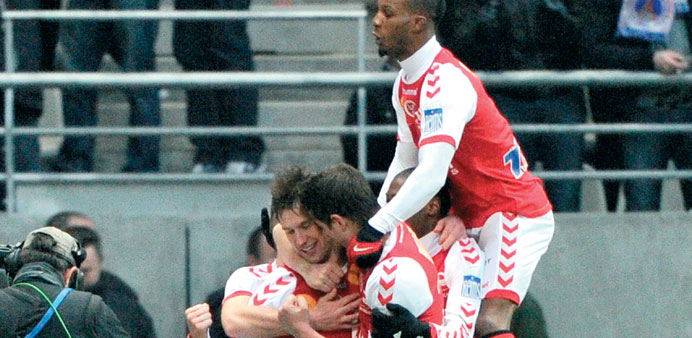 Reimsu2019 Grzegorz Krychowiak (C) is congratulated by teammates after scoring a goal during the French L1 match against PSG at the Auguste Delaune stadiu