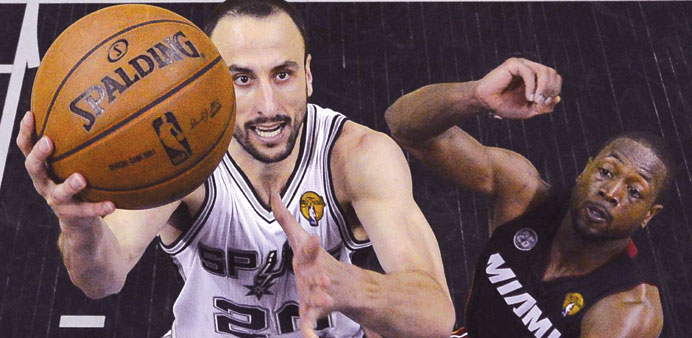 San Antonio Spurs shooting guard Manu Ginobili (left) goes for the basket past Miami Heat shooting guard Dwyane Wade during Game 5 of their NBA final 