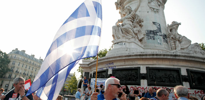 k flag as people take part in a rally in support of the people of Greece a