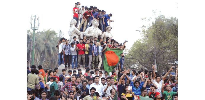Bangladesh cricket fans cheer after the national team defeated England in the International Cricket Council (ICC) World Cup game in Dhaka on March 9