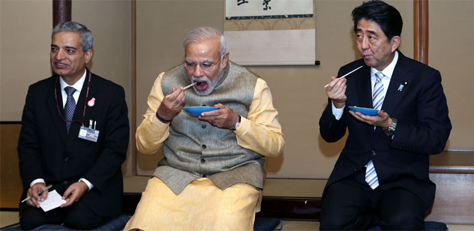 India's Prime Minister Narendra Modi (C) and Japan's Prime Minister Shinzo Abe (R) .  -EPA