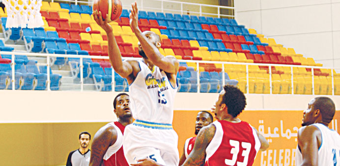 Al Gharafau2019s Monroe Samuel Jr (right) goes for the basket as Al Shaman players try to defend Picture: Nasar