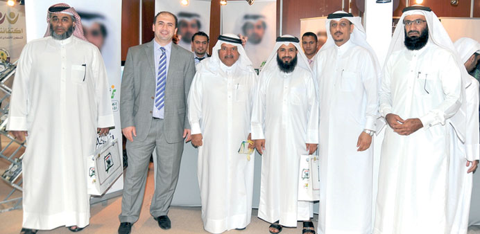 Officials and visitors at the exhibition yesterday.