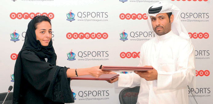 Ooredoo sponsorship analyst Manar Khalifa al-Muaikhi (L) and QSports chairman and founder Ghanim al-Mohannadi seal the deal yesterday.