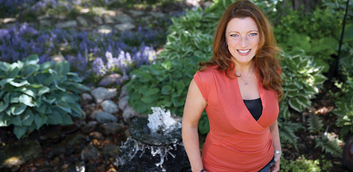 * Author-blogger Shawna Coronado is pictured in her garden outside of her Illinois home. Coronado has been working on the garden since 2007.