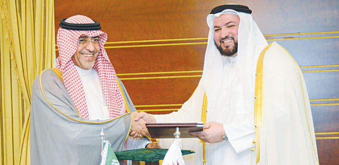 HE the Minister of Awqaf and Islamic Affairs Dr Ghaith bin Mubarak al-Kuwari and Saudi Ambassador to Qatar Abdullah bin Abdulaziz al-Aifan exchanging 