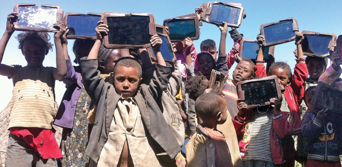  Ethiopian children with tablets in the village of Wonchi. Photographs: Michael Girma