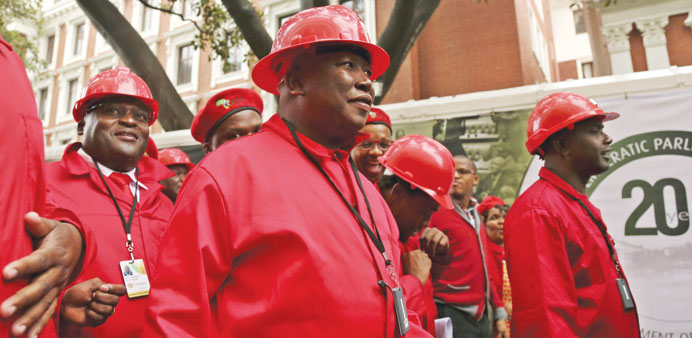 Economic Freedom Party (EFF) leader Julius Malema (C) arrives to be sworn in as a member of parliament in Cape Town yesterday.