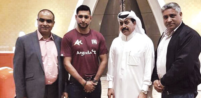 British boxer Amir Khan (second from left) with Qatar Boxing Federation president Yousuf Ali al-Kazim (second from right) after arriving in Doha yeste