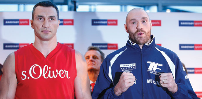Wladimir Klitschko and Tyson Fury (R) pose during the weigh-in yesterday. (Reuters)