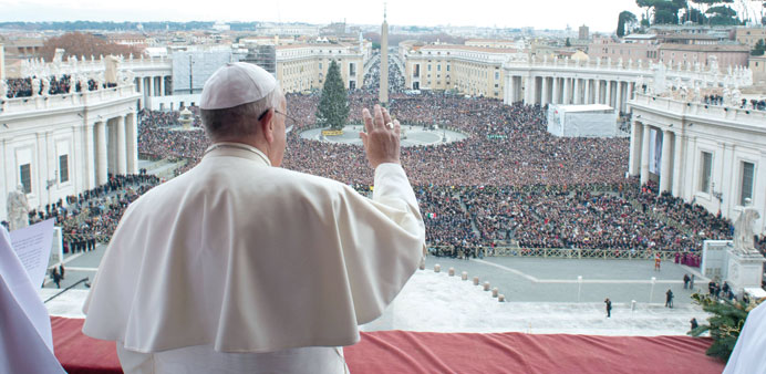 Francis waves as he delivers his first u2018Urbi et Orbiu2019 (to the city and world) message from the balcony overlooking Saint Peteru2019s Square at the Vatican