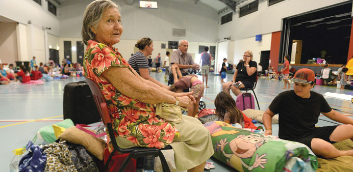  Win Bass, 86, and her family take shelter ahead of the arrival of Cyclone Ita at an evacuation centre in Cooktown, Queensland.