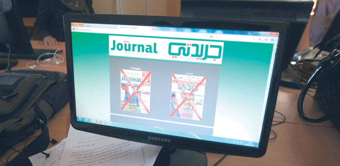 A computer screen displays the front covers of the two censored newspapers at their office in Algiers yesterday.