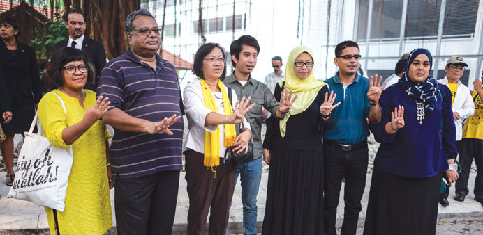 Members of Bersih -- a coalition of Malaysian NGOs and activist groups  at the police headquarters in Kuala Lumpur yesterday.