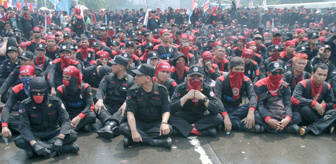 Hundreds of demonstrators block the road outside the parliament building, while parliament members hold a meeting to pass the mass organisation bill, 