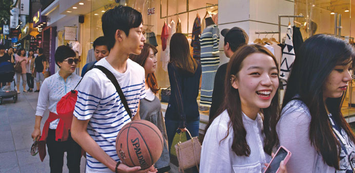 Shoppers walking in the upmarket Garuso-gil area of Gangnam, in Seoul.