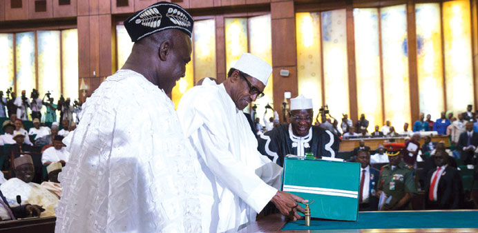President Muhammadu Buhari lays a copy of the 2016 Nigeria budget on the table at the National Assembly in Abuja yesterday.