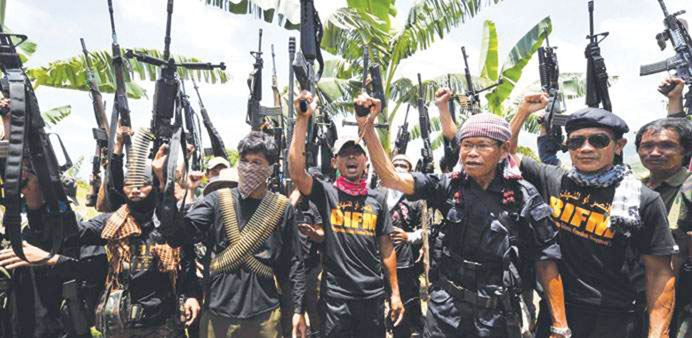 File photo shows rebels raising their weapons.