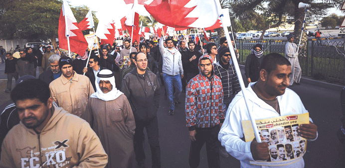  Demonstrators wave flags during the protest yesterday in the village of Barbar, west of Manama. 