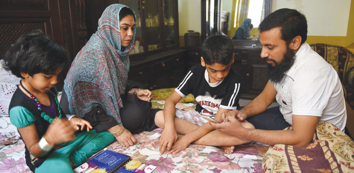   In this photograph taken on April 10, 2015, Pakistani citizen, teacher and Yemen evacuee, Saima Tanveer sits with her children and brother-in-law at