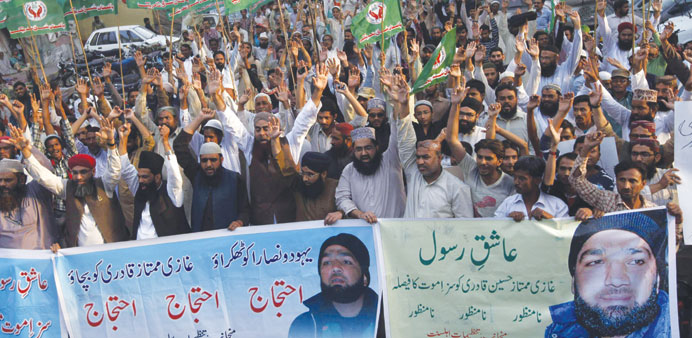 Supporters of a religious political party shout slogans during a demonstration against the sentence of convicted killer Mumtaz Qadri in Karachi.