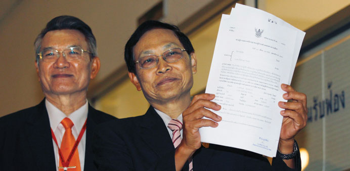 Thailandu2019s Attorney Director General, Department of Special Litigation Chutichai Sakhakorn (right) holds filed charge papers as Director General, Depa