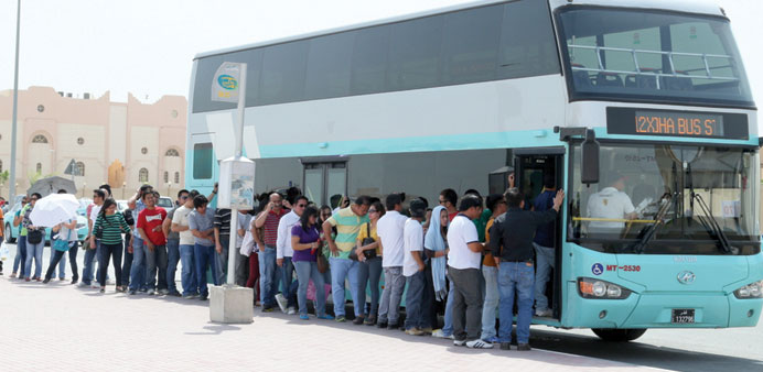 A long queue of passengers at a bus stop near the Religious Complex area