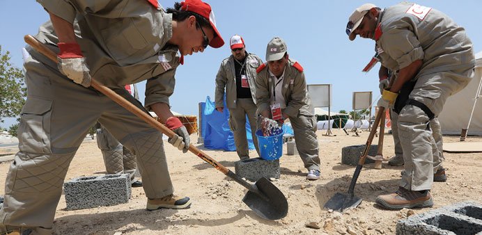 QRC volunteers work to assist in rebuilding efforts after a disaster that occurred abroad.