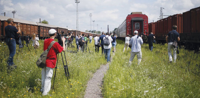 Journalists work after a train carrying the remains of victims of Malaysia Airlines MH17 arrived in Kharkiv.