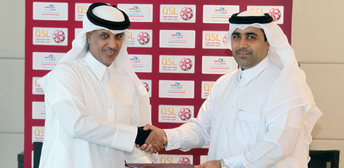 HE Sheikh Hamad bin Khalifa bin Ahmad al-Thani (left) and HE Essa bin Hilal al-Kuwari during the agreement signing ceremony.