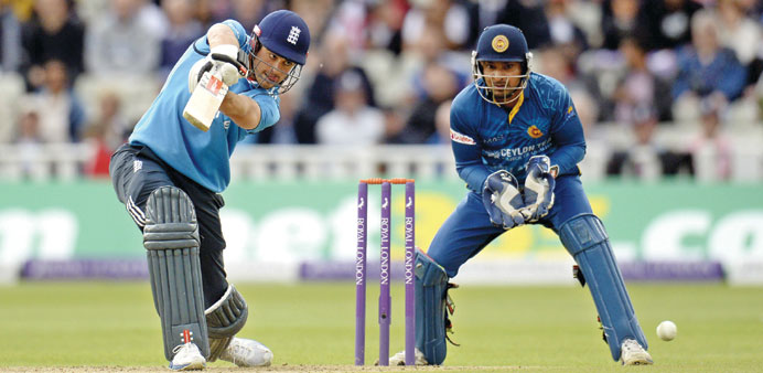 England captain Alastair Cook plays a stroke while being watched by Sri Lankan wicket-keeper Kumar Sangakkara during the fifth ODI at Edgbaston in Bir