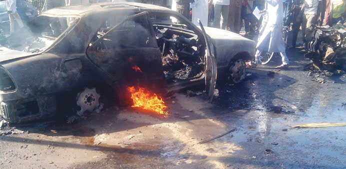 A burning car in Maiduguri moments after the blast that killed at least 17 people.