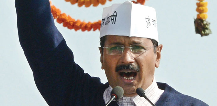 Arvind Kejriwal gestures as he addresses supporters after taking his oath of office in New Delhi.