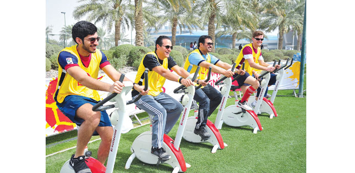 HE the Minister of Energy and Industry Dr Mohamed bin Saleh al-Sada tries one of the stationary bicycles at the Aspire Zone.