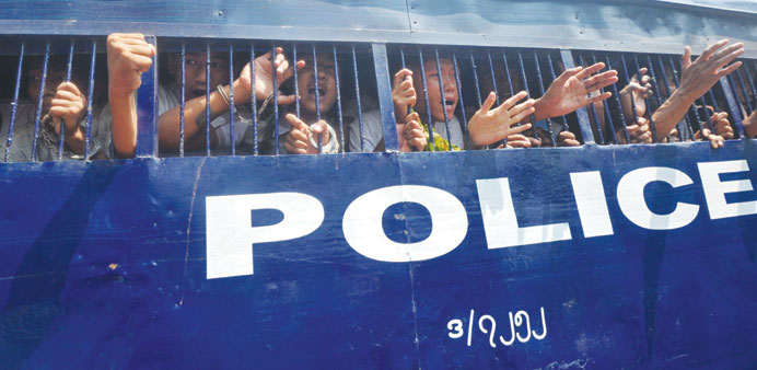 Myanmar students and activists wave as they arrive at a court for a hearing in Letpadan yesterday.