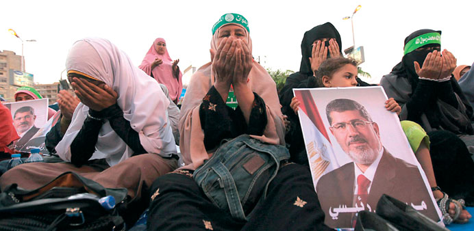 Female supporters of the Muslim Brotherhood pray during a protest in support of Mursi outside Rabaa al-Adawiya mosque in Cairo yesterday.