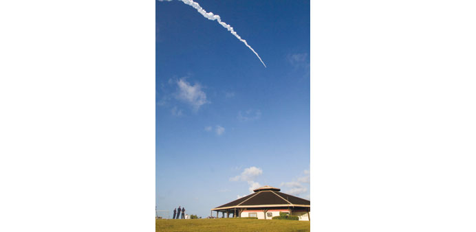 People watch the launch of Ariane-5 rocket.