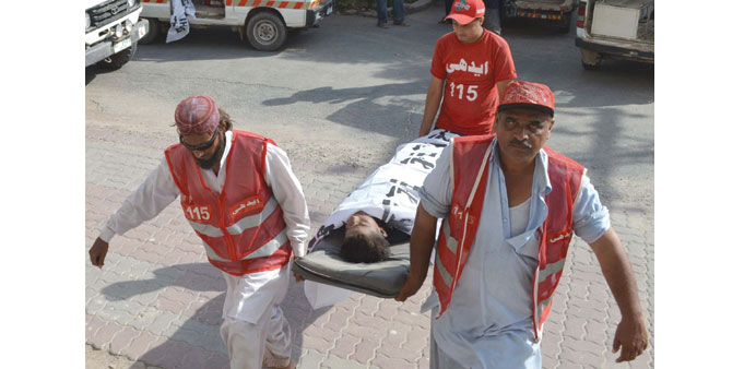 Rescue workers shifting a body of a victim who was killed after boat carrying wedding procession sank, to a hospital, in Multan yesterday.