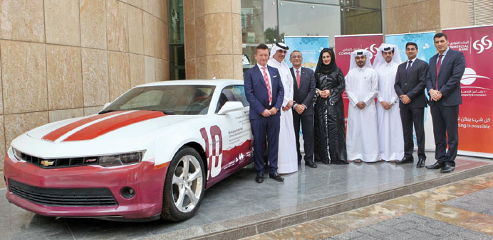 Commercial Bank and Jaidah Motors officials with a Camaro.