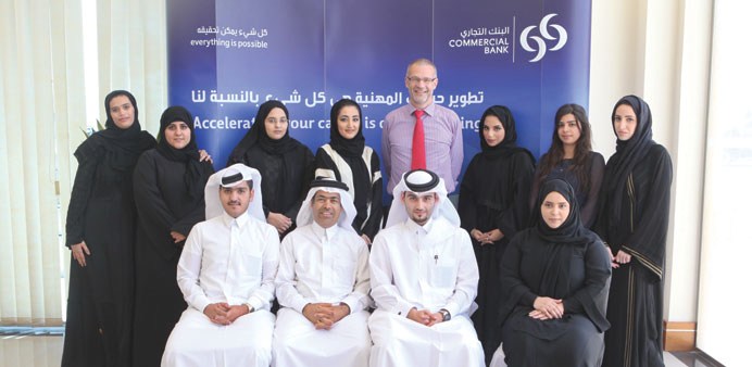 Qatari students who have joined the summer internship programme are seen with Commercial Bank officials.