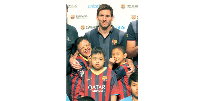 Barcelonau2019s Lionel Messi poses with children with intellectual disabilities during a Unicef event in Bangkok yesterday. (AFP)