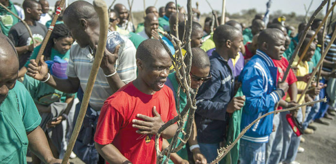 Miners take part in a procession to mark the third anniversary of the Marikana massacre near Rustenburg, South Africa.