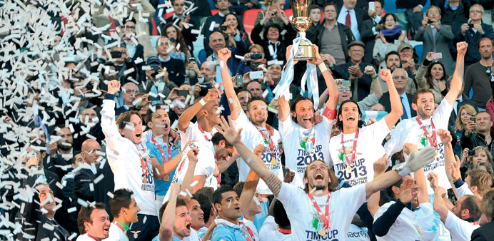  Lazio players celebrate with trophy after winning the Italian Cup final soccer match beating Roma at Olimpico stadium in Rome. Senad Lulic flicked ho