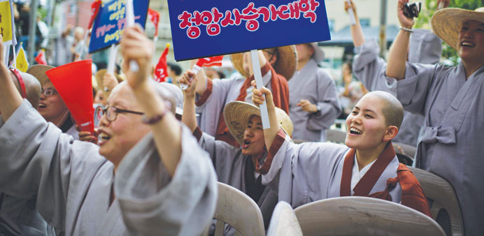 Nuns hold placards reading u2018you rocku2019 as they shout support for performers at a Buddhist prayer competition at the Jogyesa temple in Seoul.