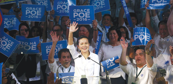 Senator Grace Poe, daughter of late local movie actor Fernando Poe Jr, waves to her supporters during her proclamation rally inside the University of 