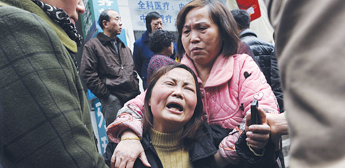 A woman cries after her parent was killed in a knifing incident in Changsha, Hunan province yesterday.