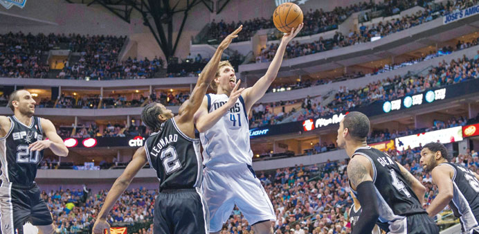 Dallas Mavericks forward Dirk Nowitzki drives to the basket past San Antonio Spurs forward Kawhi Leonard during the first half at the American Airline