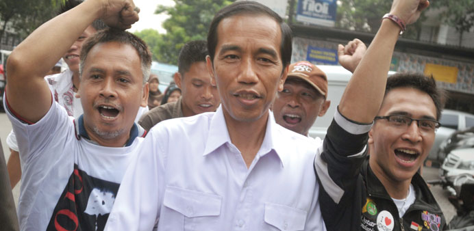 Popular presidential candidate of the main opposition party Indonesian Democratic Party of Struggle (PDI-P) and Jakarta Governor Joko Widodo (centre) 