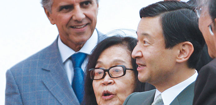 This June 21, 2008, file photo of Japanu2019s Crown Prince Naruhito (right) speaking beside artist Tomie Ohtake (centre) during a ceremony at the monument